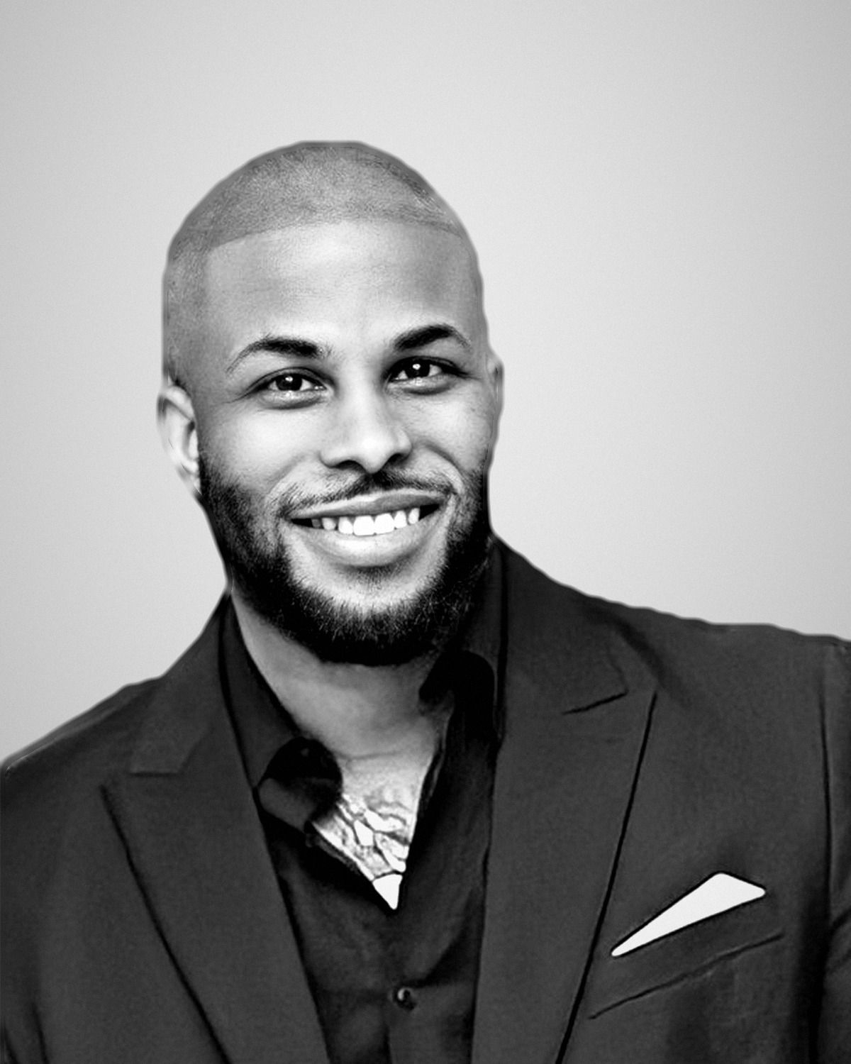 Portrait of Brian Kiser, founder and CEO of AspireCore, smiling, in a dark suit with a white pocket square.